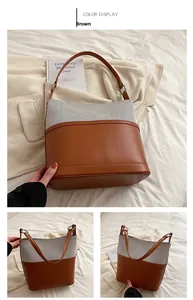 Close-up of the textured gray woven fabric and brown PU leather on this bucket bag