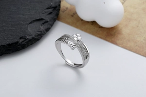 Detail of adjustable silver ring with Smile script and clover-shaped micro-pave crystals