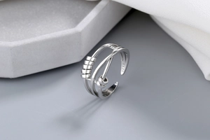 Macro view of S925 sterling silver ring showing three bands and sliding geometric beads