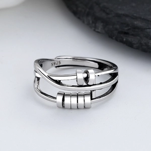 Macro detail of S925 sterling silver spinning ring with moving beads for stress relief