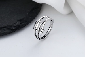 Macro shot of S925 sterling silver spinning beads on a layered adjustable fidget ring