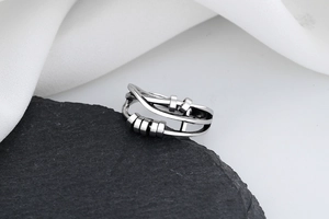 Detailed macro view of vintage silver fidget ring with sliding beads on a stone pedestal