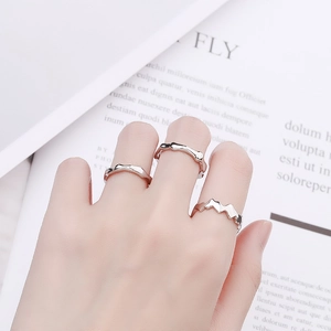 Three-piece set of minimalist silver geometric rings in wavy and bamboo textures
