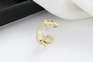Detailed view of hollow heart-shaped open ring in polished gold finish with smooth metal luster