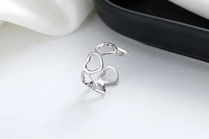 Detailed view of hollow heart pattern on adjustable silver open ring band