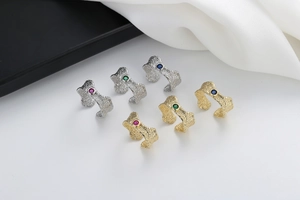 Detailed view of lava texture rings in gold and silver with colorful zircon inlays