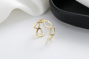Detailed close-up of hollow heart-shaped open ring in polished gold finish