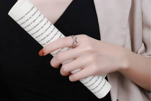 Close-up of hollow heart-shaped open ring worn on finger for a stylish, elegant look