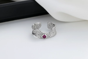 Detail of adjustable silver ring with hammered texture and pink zircon stone