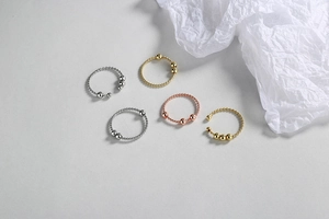 Detail of 5-piece stackable beaded twist rings in silver, gold and rose gold finishes