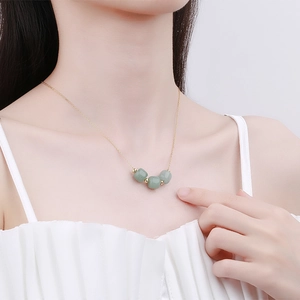 Elegant gold necklace with three green Hetian jade beads on a delicate chain for women