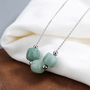 Elegant S925 silver necklace with three light green Hetian jade beads on white knit cloth
