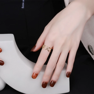 Minimalist gold hollow heart-shaped open ring shown on model hand with elegant styling