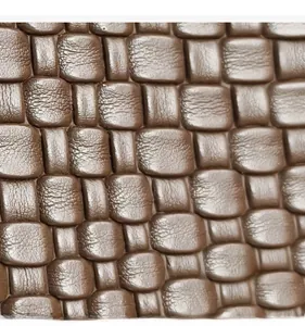 Macro shot of dark brown woven leather texture with detailed lychee grain finish