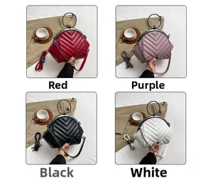 Quilted shell bags in red, purple, black and white with metal ring handles and chains