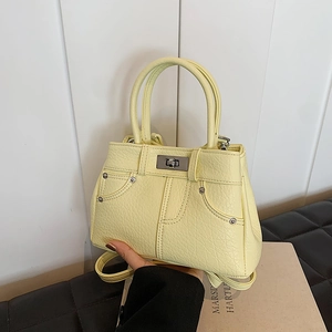 Lemon yellow faux leather handbag with stitching and silver turn-lock closure