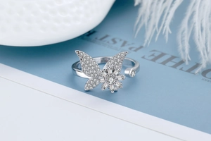 Detail shot of shimmering butterfly zircon adjustable ring on elegant props