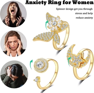 Detailed view of spinning anxiety rings with rotating butterfly and star moon designs