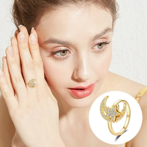 Luxury gold star and moon rotating ring with zircon stones shown on a model's finger