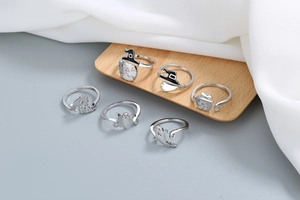 Detailed view of Halloween rings set featuring pumpkin, witch hat, and ghost charms