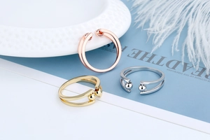 Close-up of adjustable anxiety relief rings in gold silver and rose gold bead designs