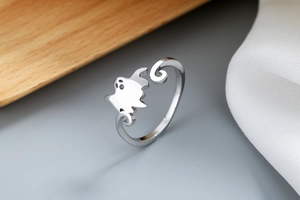 Macro view of a minimalist silver ghost ring with hollowed-out eyes and open band design