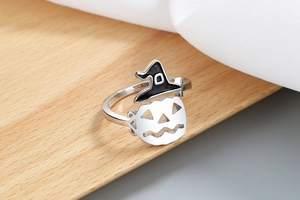 Detailed close-up of a silver Halloween ring featuring a pumpkin face and witch hat
