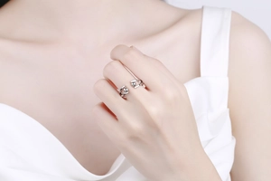 Close-up of minimalist silver adjustable stress ring with spinning beads on model finger