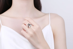 Detail of silver wizard hat ring with black enamel accents worn on a finger