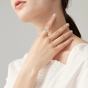 Close-up of adjustable silver spinning beads ring on finger for anxiety relief