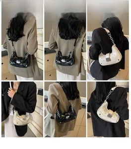 Detail shots of crescent crossbody bag worn by model in black and off-white colors