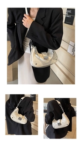 Detail view of cream hobo bag with quilted leather texture and metal chain strap