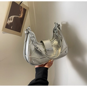 Detail of silver crescent underarm bag with vintage pleated leather and chunky chain
