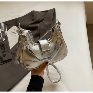 Detail view of silver crossbody bag featuring metallic crackle texture and chain strap
