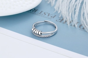 Detail of S925 sterling silver spinning ring featuring four rotating beads and zircon