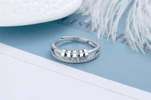 Macro shot of rotatable beads on a double-layered ring with sparkling zircon inlays