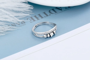 Macro detail of S925 sterling silver spinning ring with zircon stones and movable beads