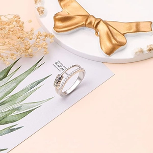 Close-up of rotatable silver ring with sparkling zircon pavé and three moving metal beads