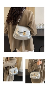 Detailed view of silver metallic pleated shoulder bag with gold triangle buckle closure