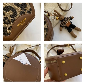 Detail of vintage brown round bag with leopard print, bunny charm, and back card slot