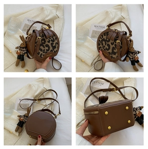 Detailed views of a round crossbody bag with leopard print and a rabbit charm