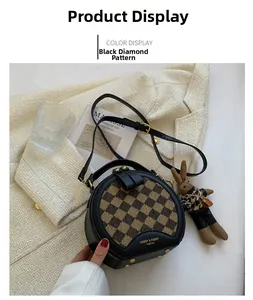 Close-up of black and yellow checkered round handbag with cute bunny charm detail