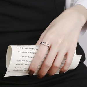Romantic silver heart hands gesture ring for couples with minimalist aesthetic