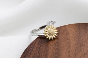 Close-up detail of silver sunflower ring with yellow petals and sparkling zircon gemstone