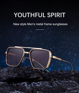 Close-up of new men's metal sunglasses featuring gold frames and dual bridge on dark rock