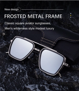 Detail of square pilot sunglasses with matte metal frame on rock next to leather case