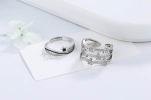 Detailed view of silver star rings with micro-pave cubic zirconia and black enamel inlay