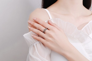 Detail view of double-layered silver star ring with white zircons on a model finger