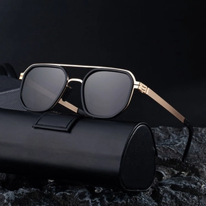Detail of premium men's irregular sunglasses featuring gold metal temples and dark lenses