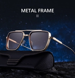 Macro shot of gold metal pilot sunglasses with textured frames on a starry night background